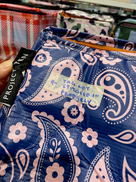 Product tag not stitched In properly and the middle of the tag has fabric mildly splayed open.