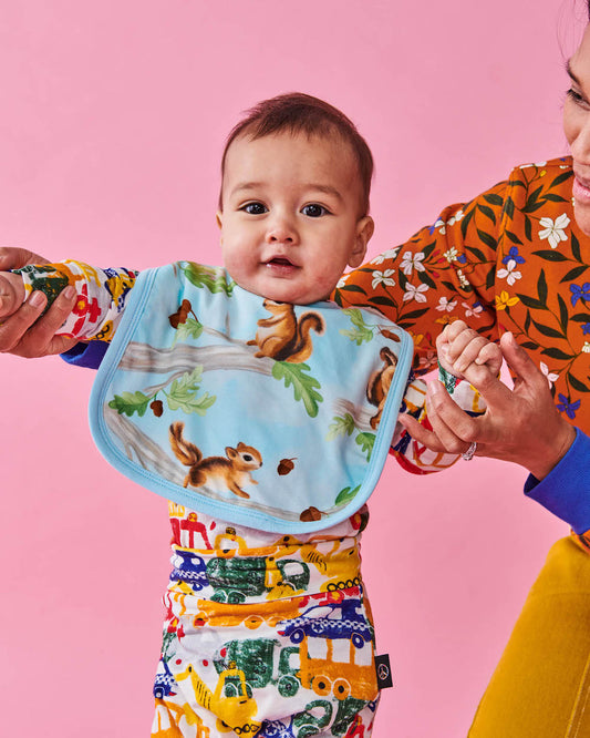 Kip & Co Squirrel Scurry Bib modelled by baby