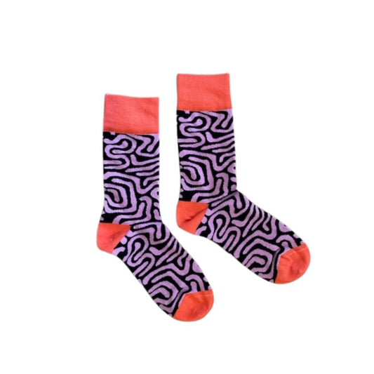 A pair of Afropop socks with a purple and navy pattern and orange accents on a white background