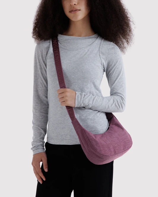 Person wearing a purple bag against a plain background