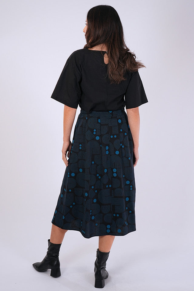 Back view of model wearing Essaye Isabel Bauhaus Skirt in Black/Blue.