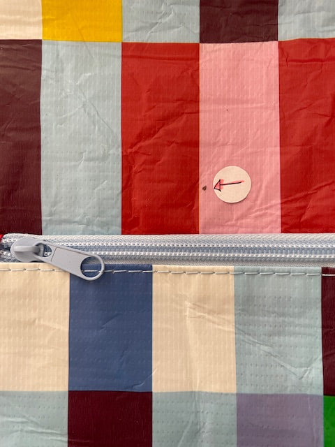 Mark on front of pencil case. Arrow sticker pointing to mark.