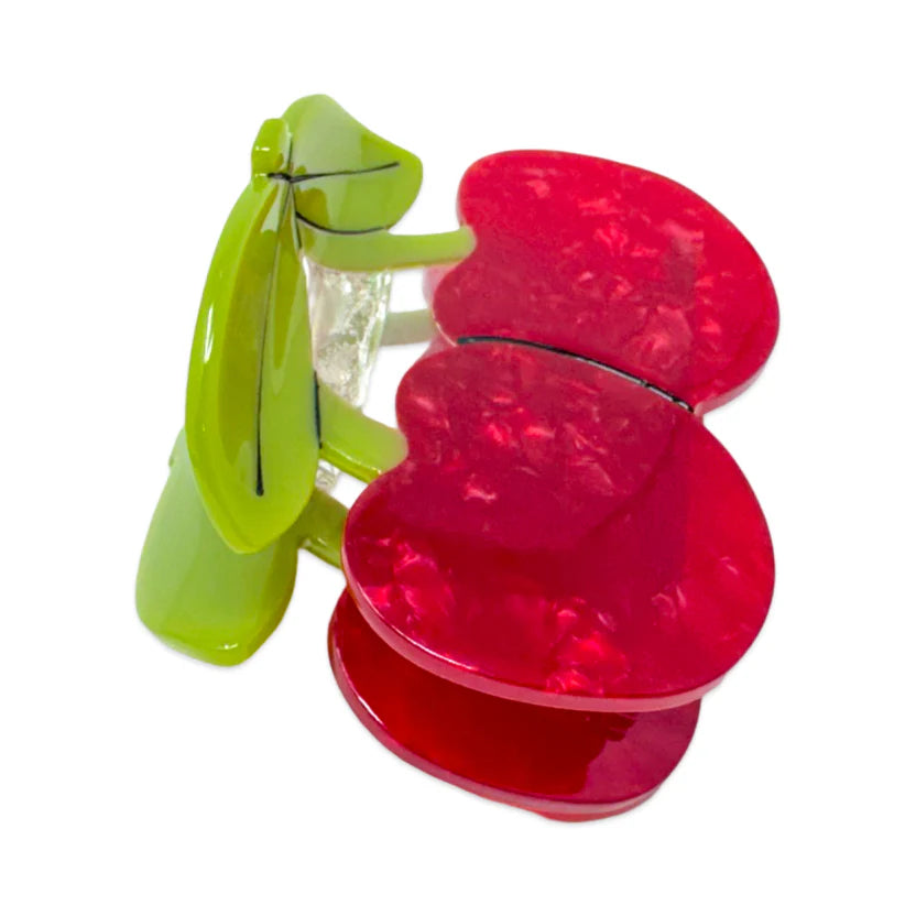 Side view of a Red cherry-shaped hair clip with green leaves, on a white background.