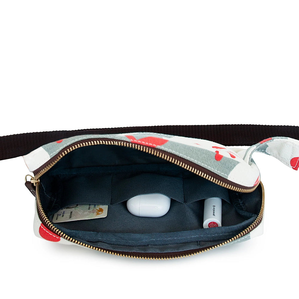 Styled image of Maika Bum Bag in Enid with a credit card, air pods case and a lipstick in the inside pockets.