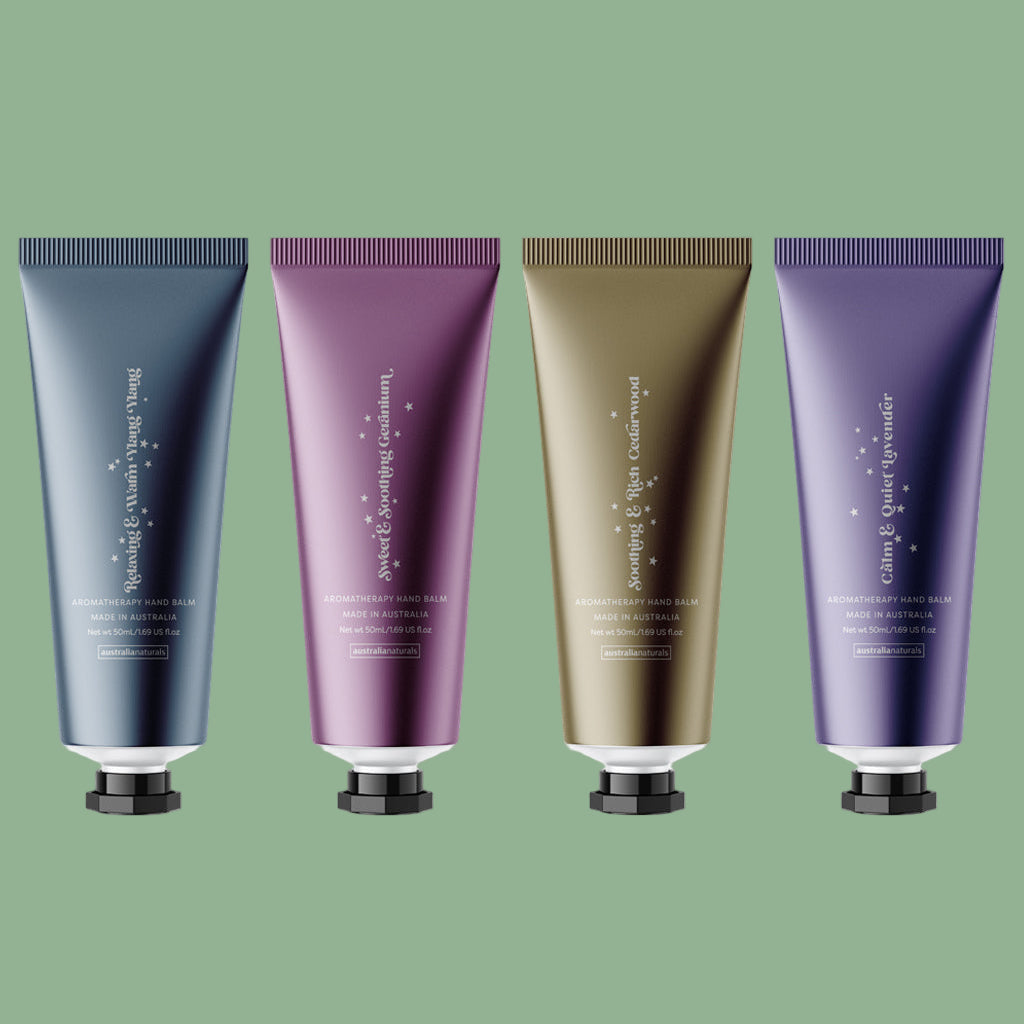 Four tubes of hand cream in different colors on a white background