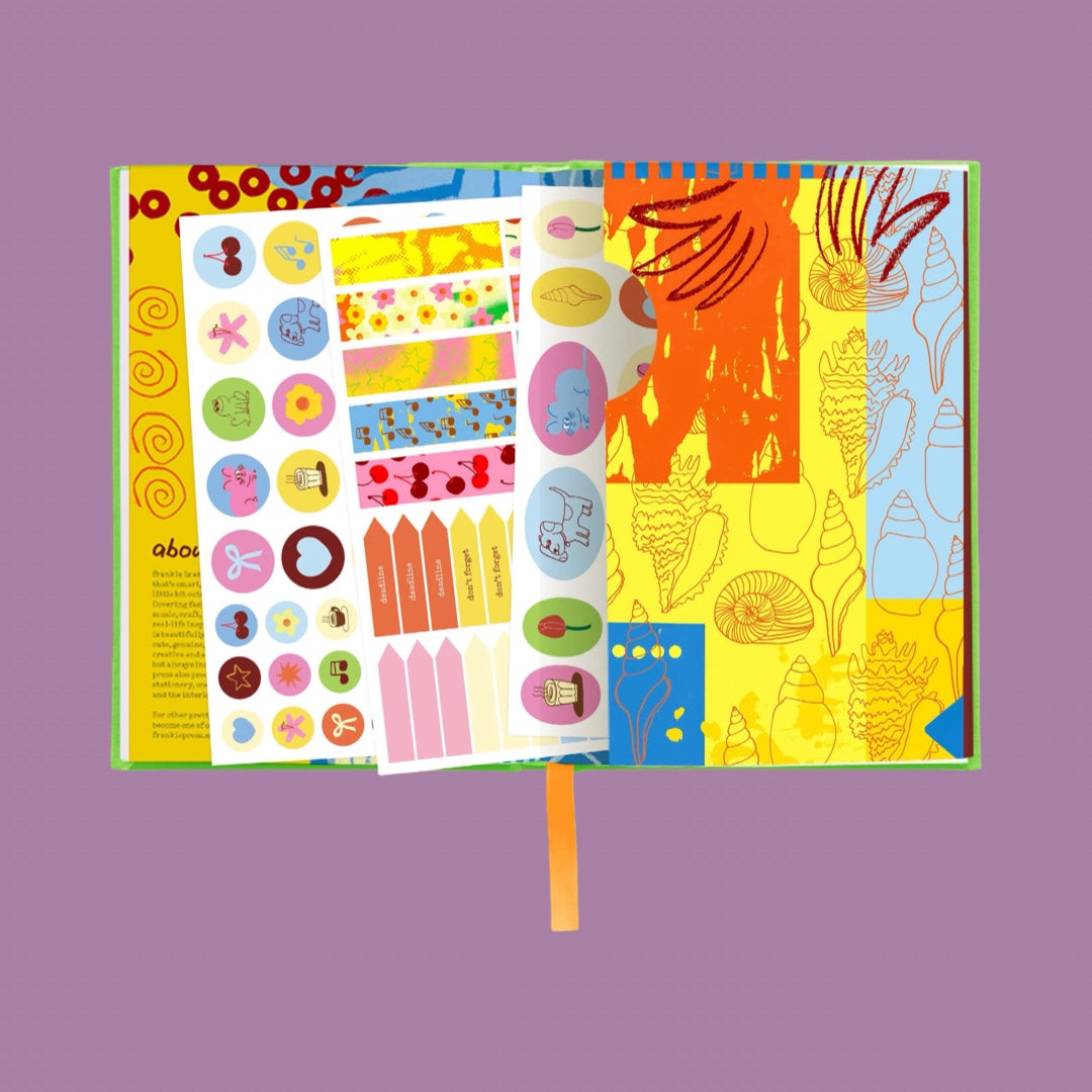 An open colorful book or art print with illustrated pages, shown against a solid muted purple background. The pages feature abstract patterns, small circular illustrations, and decorative elements in yellow, orange, blue, pink, and green.