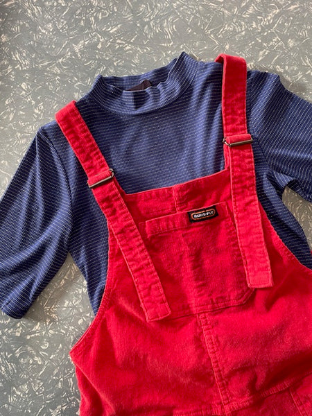 flat lay of Frock Me Out Lurex Stripe Mock Neck Tee in Red paired with red dungarees