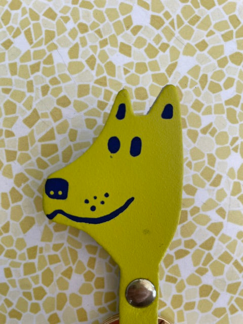 Close up showing imperfections of a tiny dot below left eye and small glue residue right of mouth.