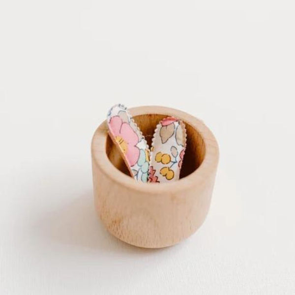 Josie Joan's Mini Hair Clips in Poppy in a small wooden cup