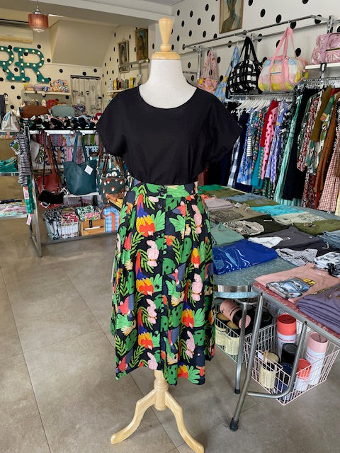 Front view of Mabel our Mannequin wearing Origami Doll Ashley Birds of Australia Skirt with a black top
