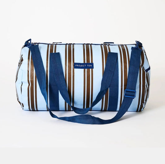 Striped duffel bag with blue straps on a white background