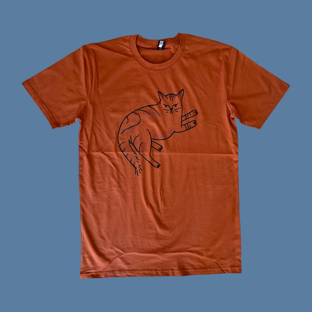 Orange t-shirt with a black cat illustration on a blue background