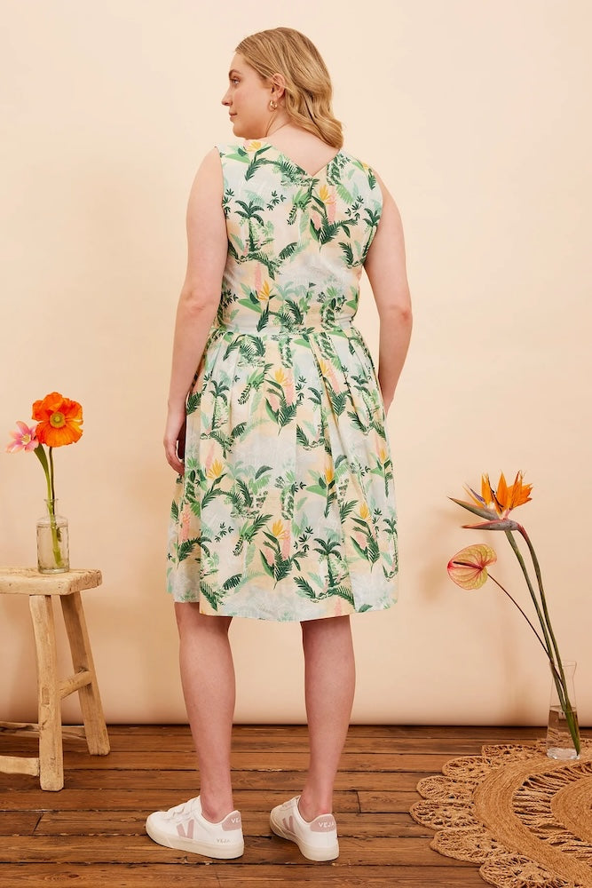 Back view of model wearing Emily & Fin Scarlett Victorian Glasshouse Dress paired with white sneakers.