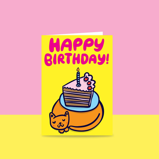 Able & Game Cake on Cat Happy Birthday Card. Features hand-drawn text "Happy Birthday" and a slice of 3-tier birthday cake with a candle on top atop a sleeping cat.