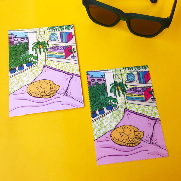 Flatlay of Able & Game Cat on Bed Microfibre Cloth with its packaging sleeve and a pair of sunnies