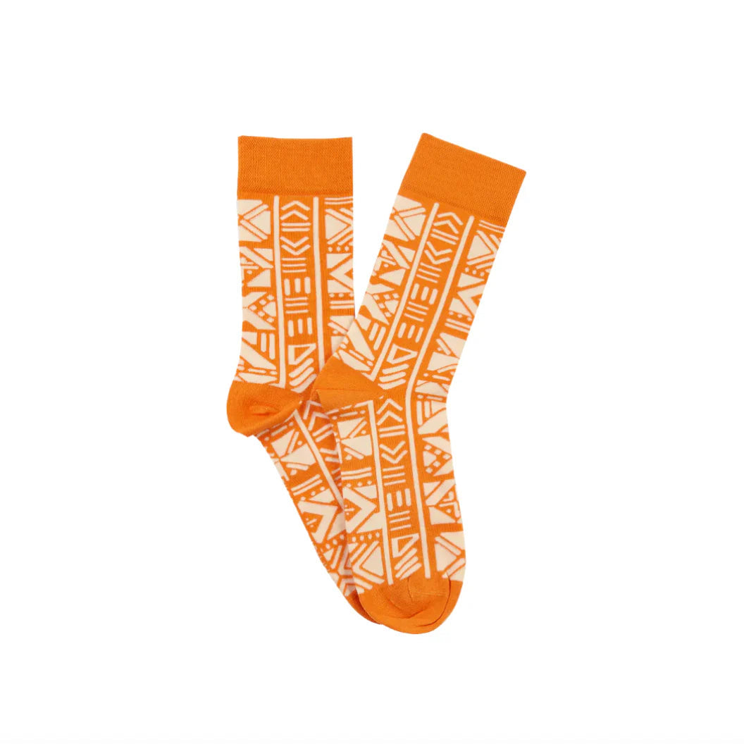Orange socks with white geometric pattern on a white background