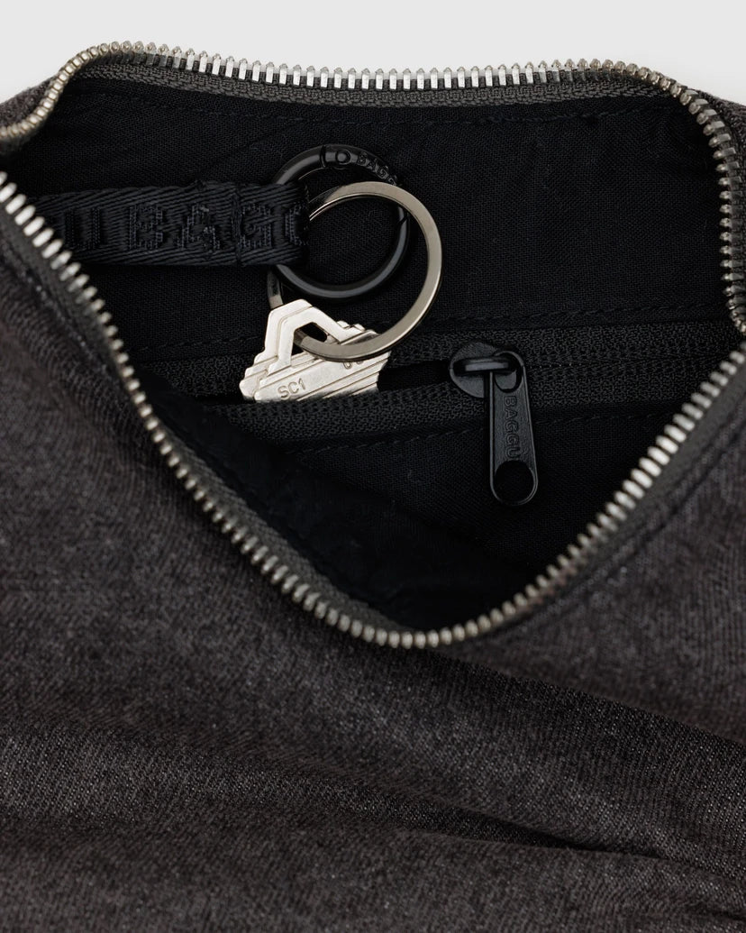 Close up of the inside of the denim bag featuring a zipper and keychain