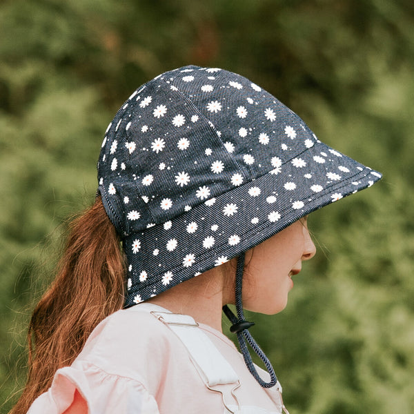 Side view of Bedhead Dani Bucket Hat worn by young model with ponytail pulled through the hat