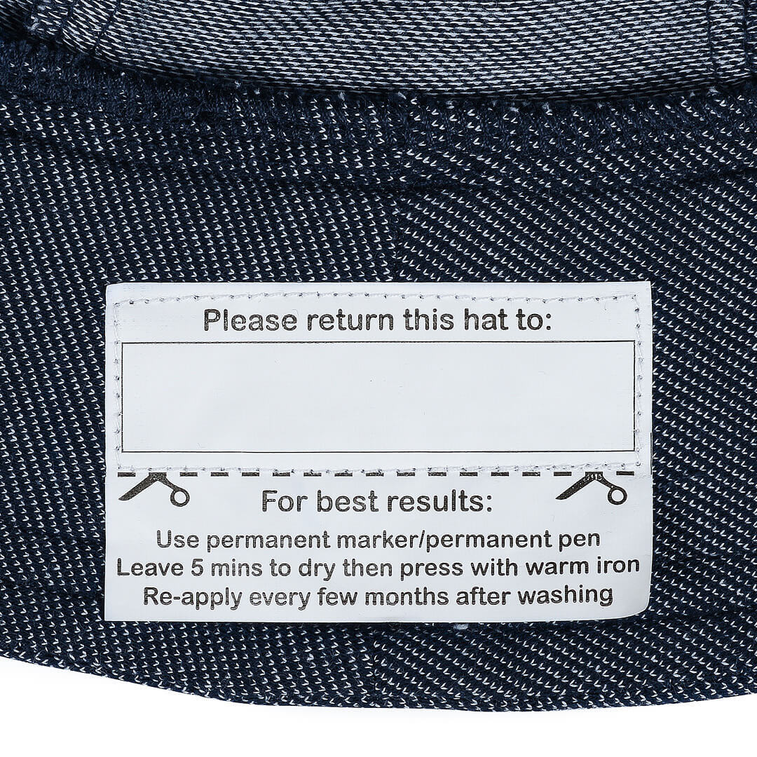 Label on a denim hat with care instructions.