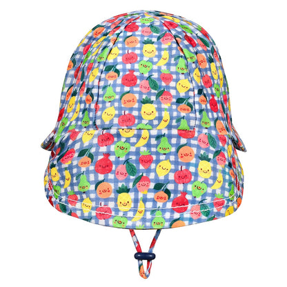 A children's bucket hat with a blue and white gingham pattern and a colourful print of smiling cartoon fruits, including pineapples, strawberries and oranges. It features an adjustable chin strap with a dark blue toggle.
