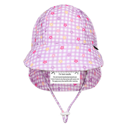 A light purple and white gingham swim hat with small pink, yellow and orange floral prints, featuring an adjustable chin strap and a name label on the back.
