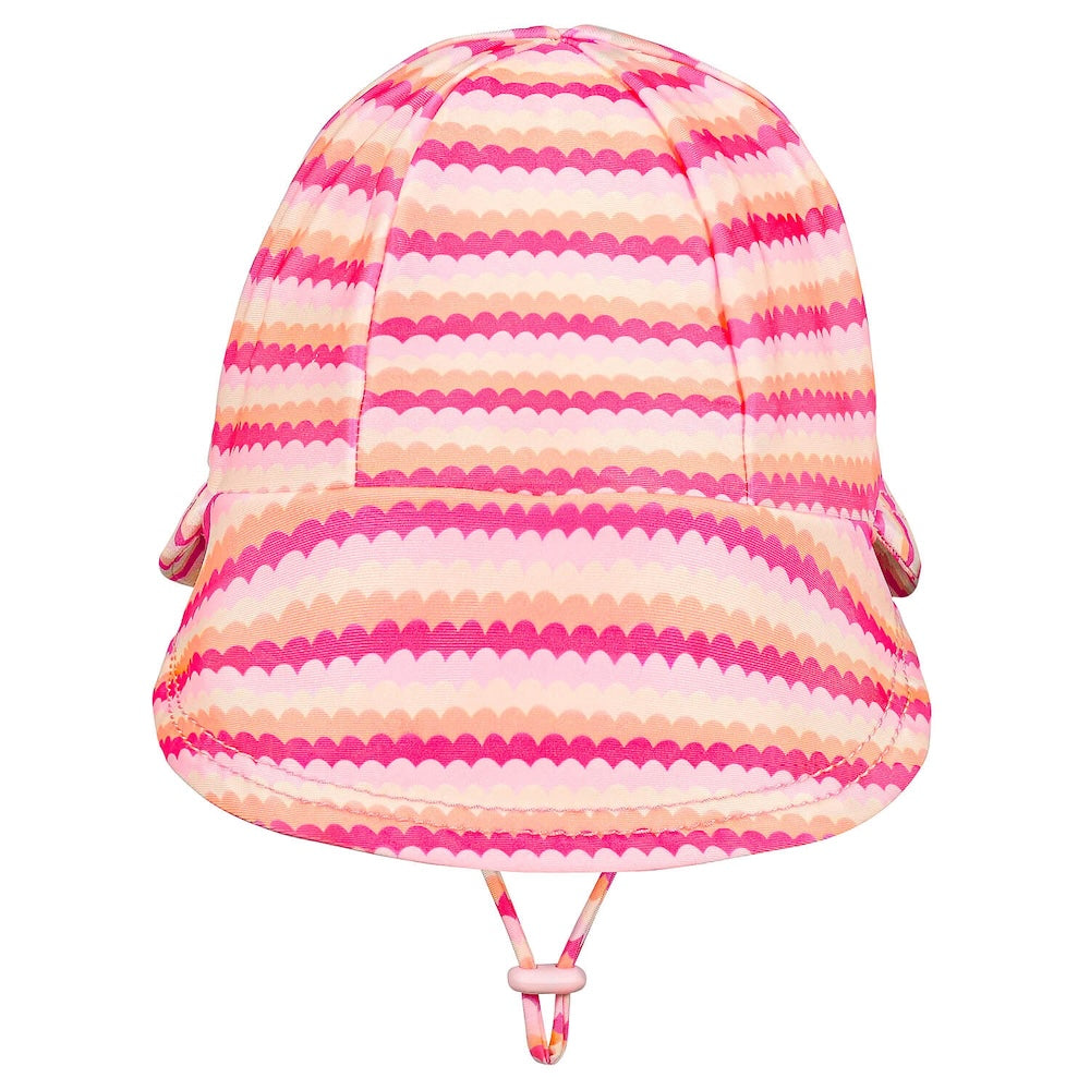 A pink and peach striped sun hat with a scalloped pattern, featuring a chin strap, shown against a plain white background.