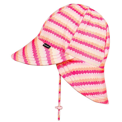 A children's swim hat with a pink, orange, and cream scalloped stripe pattern, featuring a small black Beadhead tag on the side and a chin strap with a toggle.