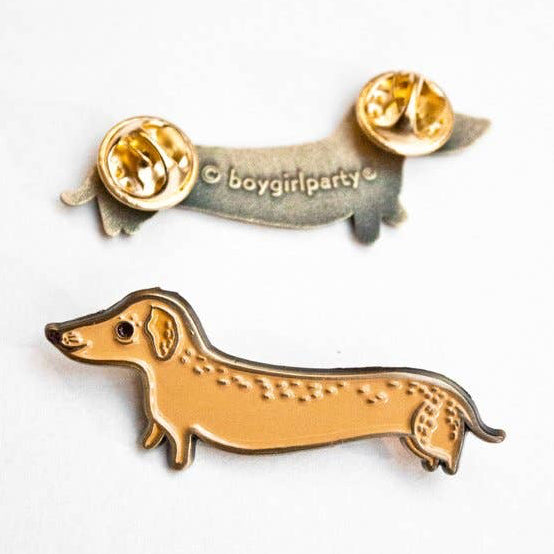 Dachshund-shaped enamel pin from the front and the back on a white background. 