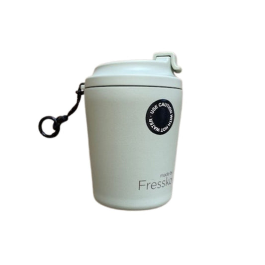 Pale sage green reusable cup with a black hang loop on a white background