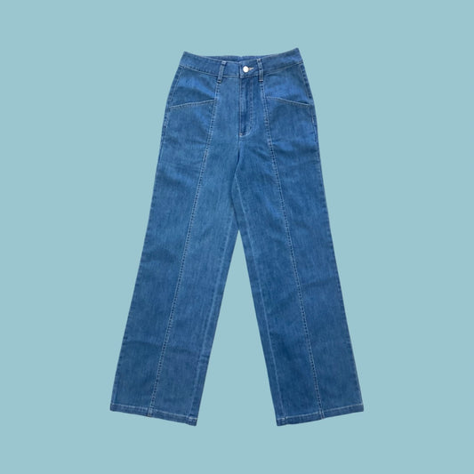 Frock Me Out denim jeans in a vintage blue wash on a pale blue background