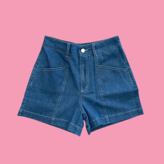 Frock Me Out Denim High Waisted Shorts - Vintage Wash. Blue denim shorts on a pink background