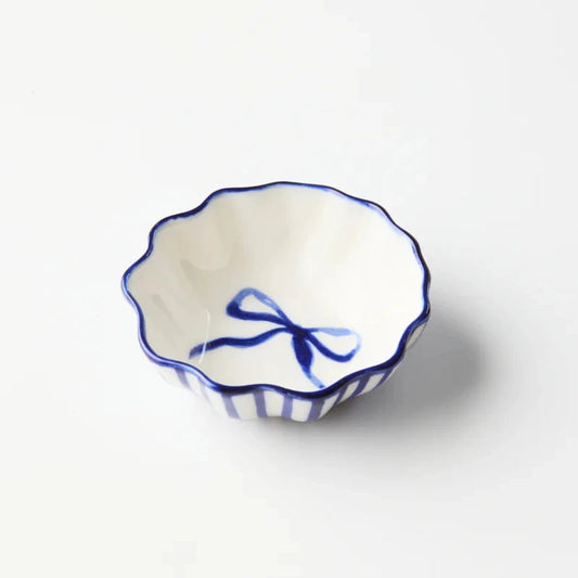 Small ceramic bowl with blue decorative elements on a white background