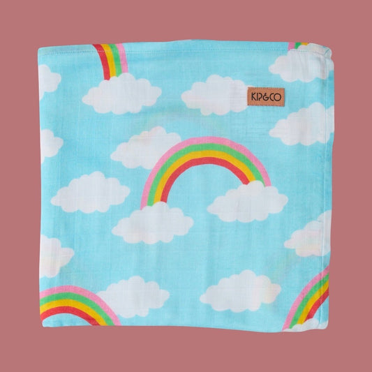 Kip & Co Cloudy Dayz Bamboo Baby Swaddle - Children's blanket with rainbow and cloud pattern on a pink background