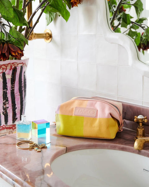 Kip & Co Corfu Tartan Toiletry Bag styled on a marble sink