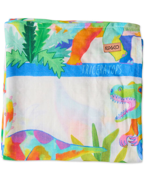 The Kip & Co Dino Safari Bamboo Baby Swaddle folded and showing off the multicoloured dinosaurs. The background is white.