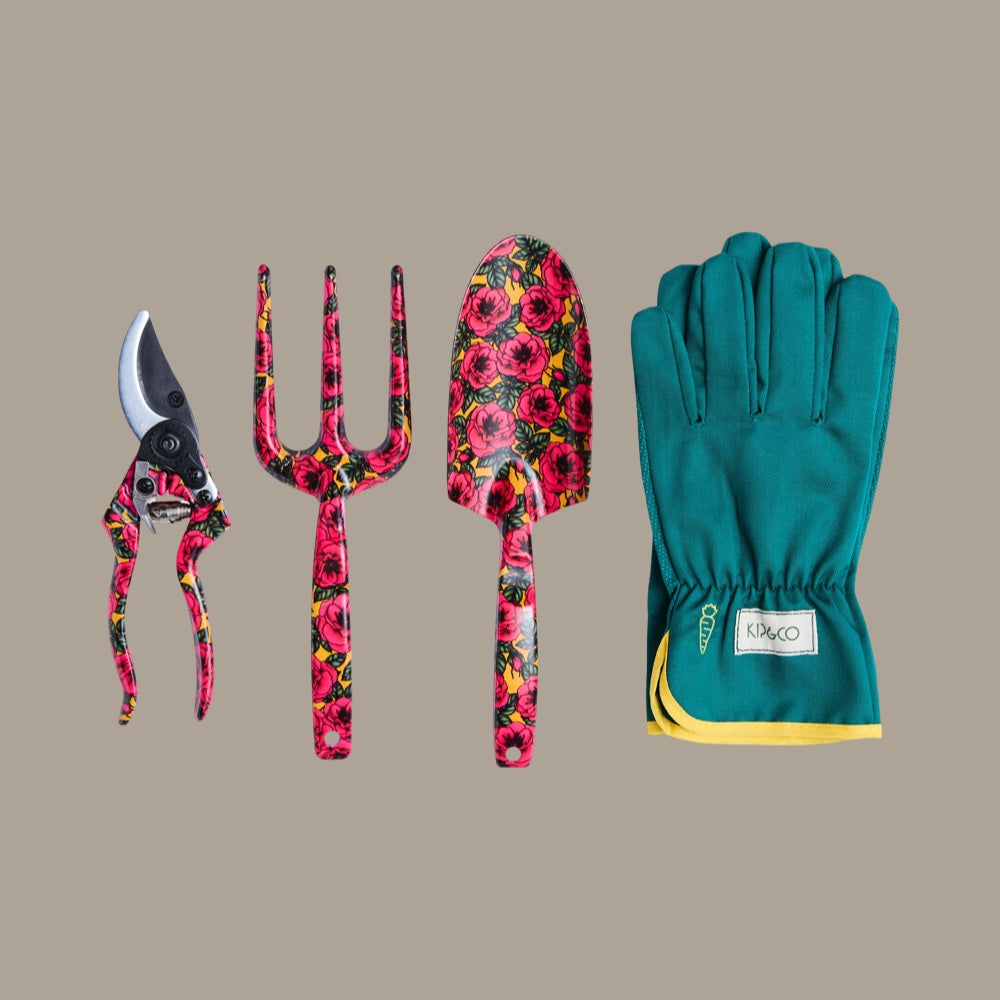 Gardening tools with floral design and a pair of green gardening gloves on a beige background