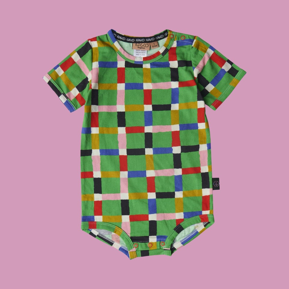 Kip & Co Jolly Tartan Short Sleeve Romper. Colourful checkered baby onesie on a pink background