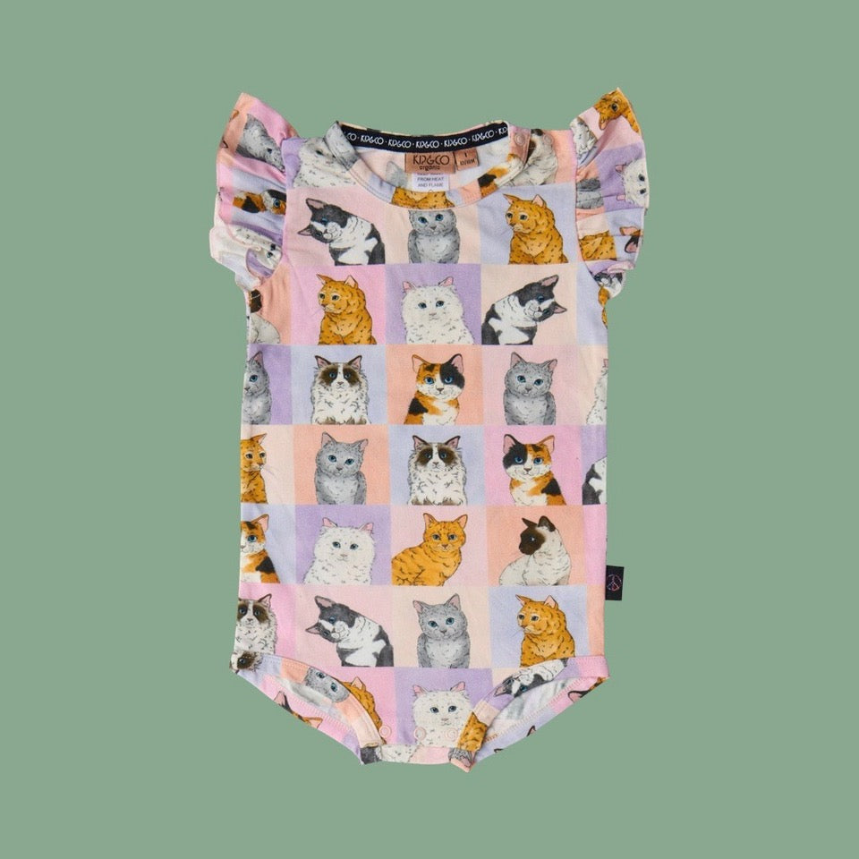 Kip & Co Kitty Cat Short Sleeve Frill Romper - a baby romper with cat pattern on a green background