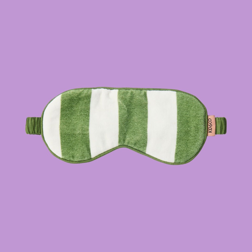 Kip & Co Moss Stripe Velvet Eye Mask - Green and white striped eye mask on a purple background