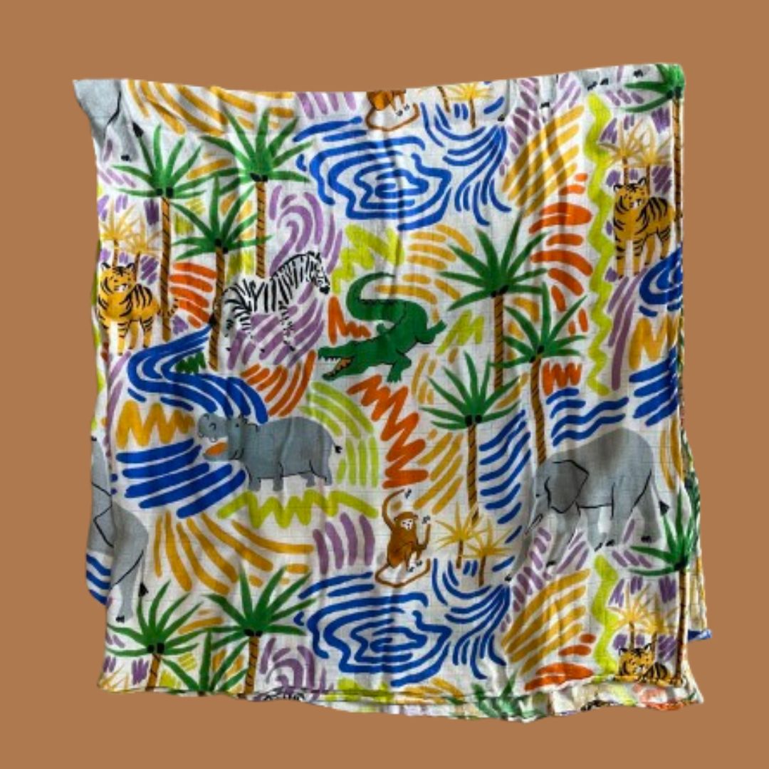 A folded swaddle featuring illustrations of the savannah including hippos, elephants, monkeys, tigers, crocodiles and zebras amongst palm trees and water.