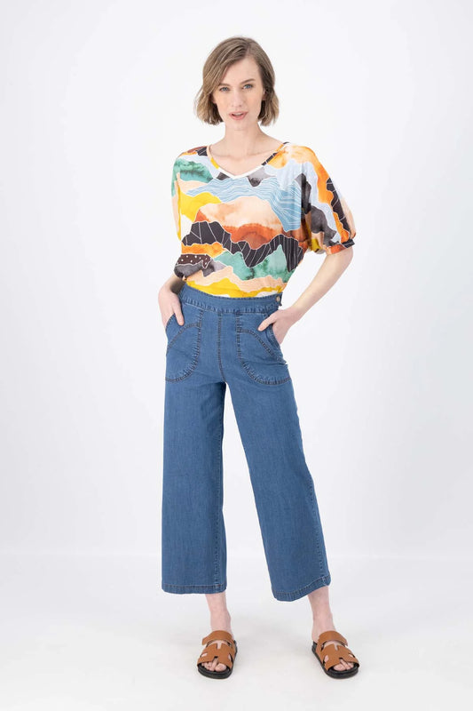 Model is wearing Olga de Polga Peggy Ligera Jeans - Light Wash in Summer Denim