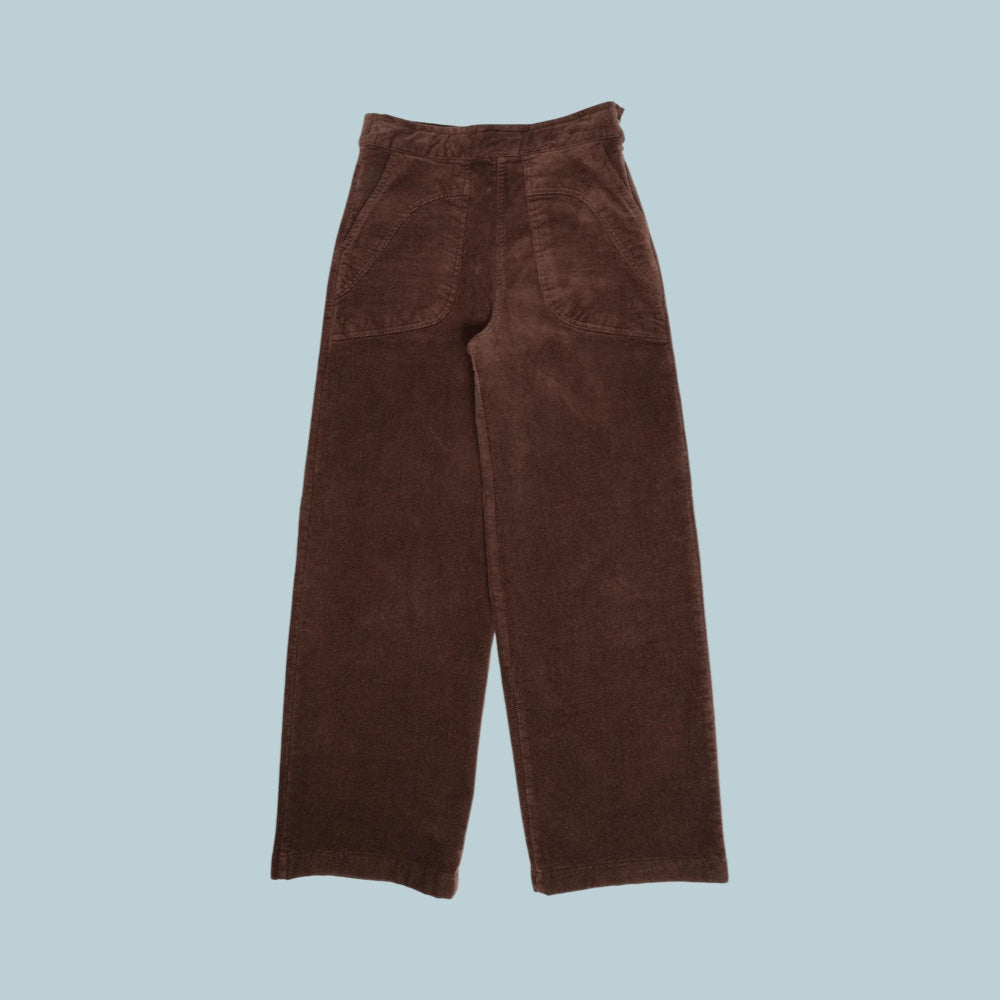 Brown corduroy pants on a pale blue grey background