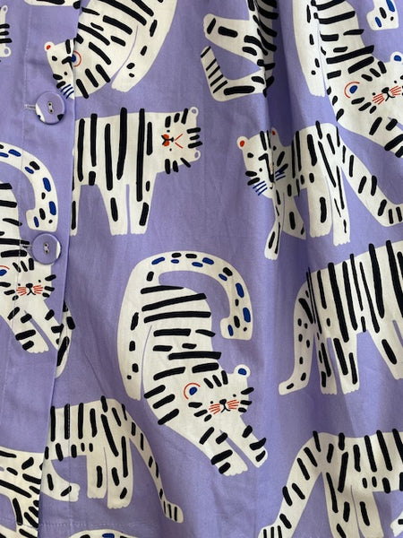 Close up of Origami Doll Penelope Tiger Dress fabric