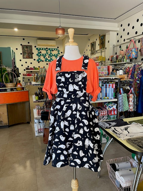Mabel is wearing a black dress with white ghost patterns in our Ruck Rover store