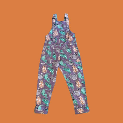 Purple overalls with cats pattern on an orange background