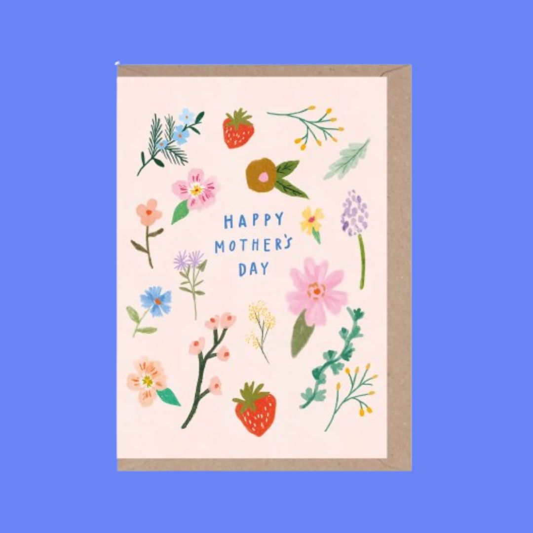 A Mother's Day greeting card with a kraft paper envelope, featuring a cream background decorated with colorful hand-drawn flowers, leaves, and strawberries, with the text 'HAPPY MOTHER'S DAY' in blue.