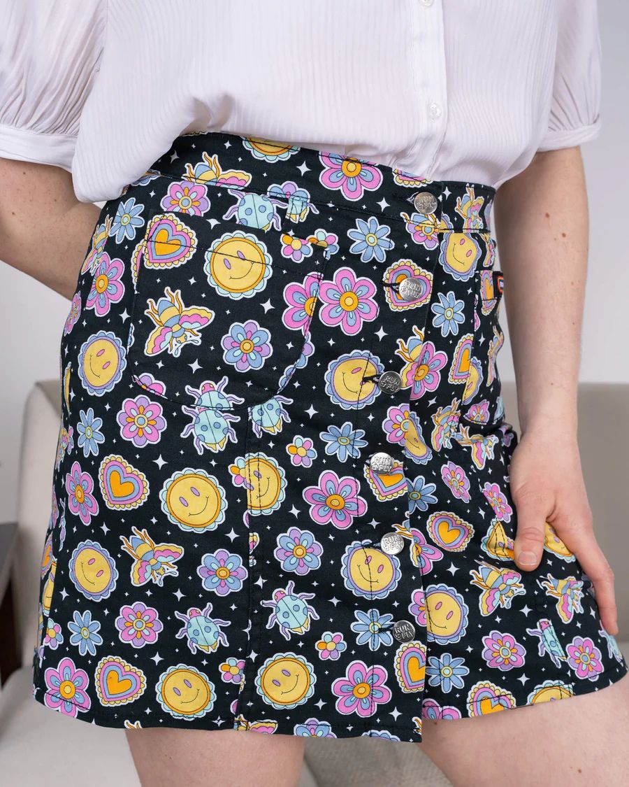 Close up of Run and Fly Bee Happy Mini Skirt worn by model.
