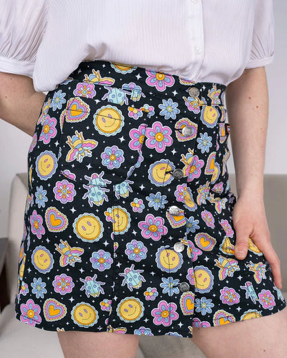 Close up of Run and Fly Bee Happy Mini Skirt worn by model.