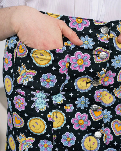 Close up of pocket details of Run and Fly Bee Happy Mini Skirt. Model has one hand inside the pocket.