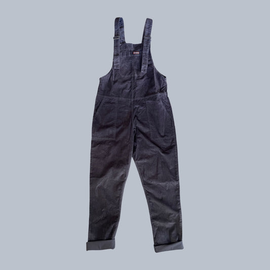A pair of Run & Fly charcoal corduroy dungarees with adjustable shoulder straps and cuffed hems, shown flat against a solid light grey background.